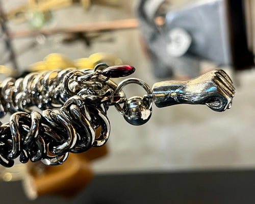 Close-up of a silver bracelet with a unique design and charm.